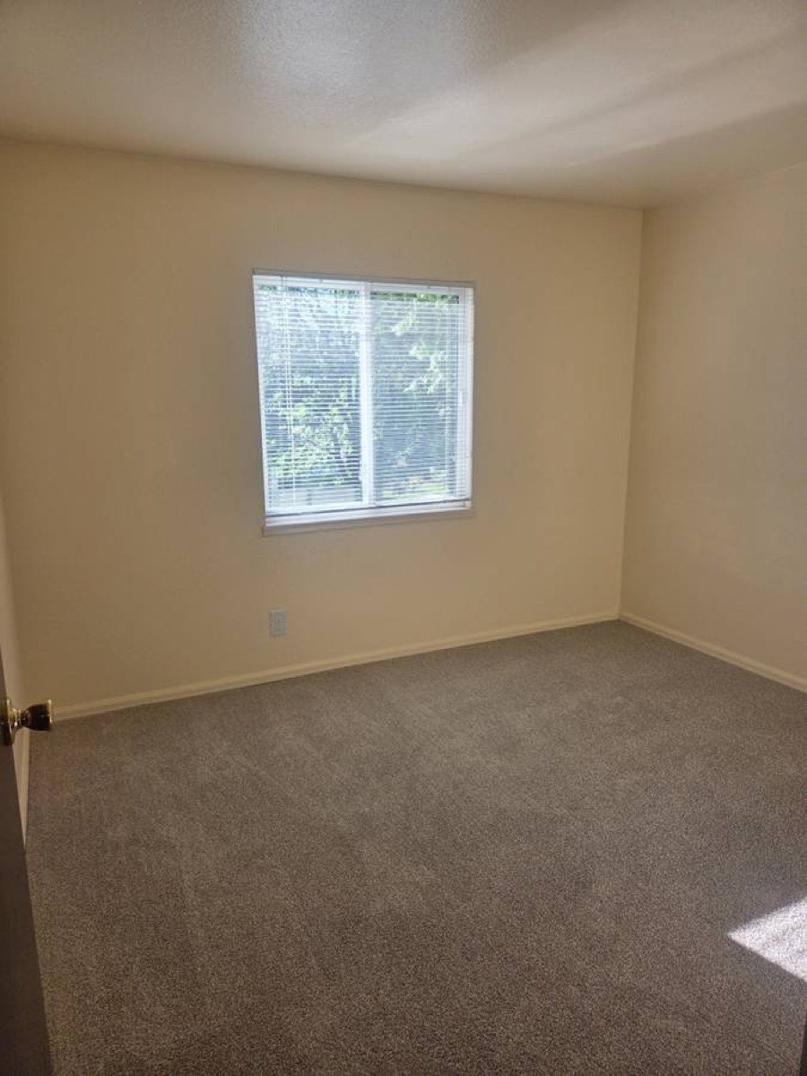 Bedroom with large window and closet