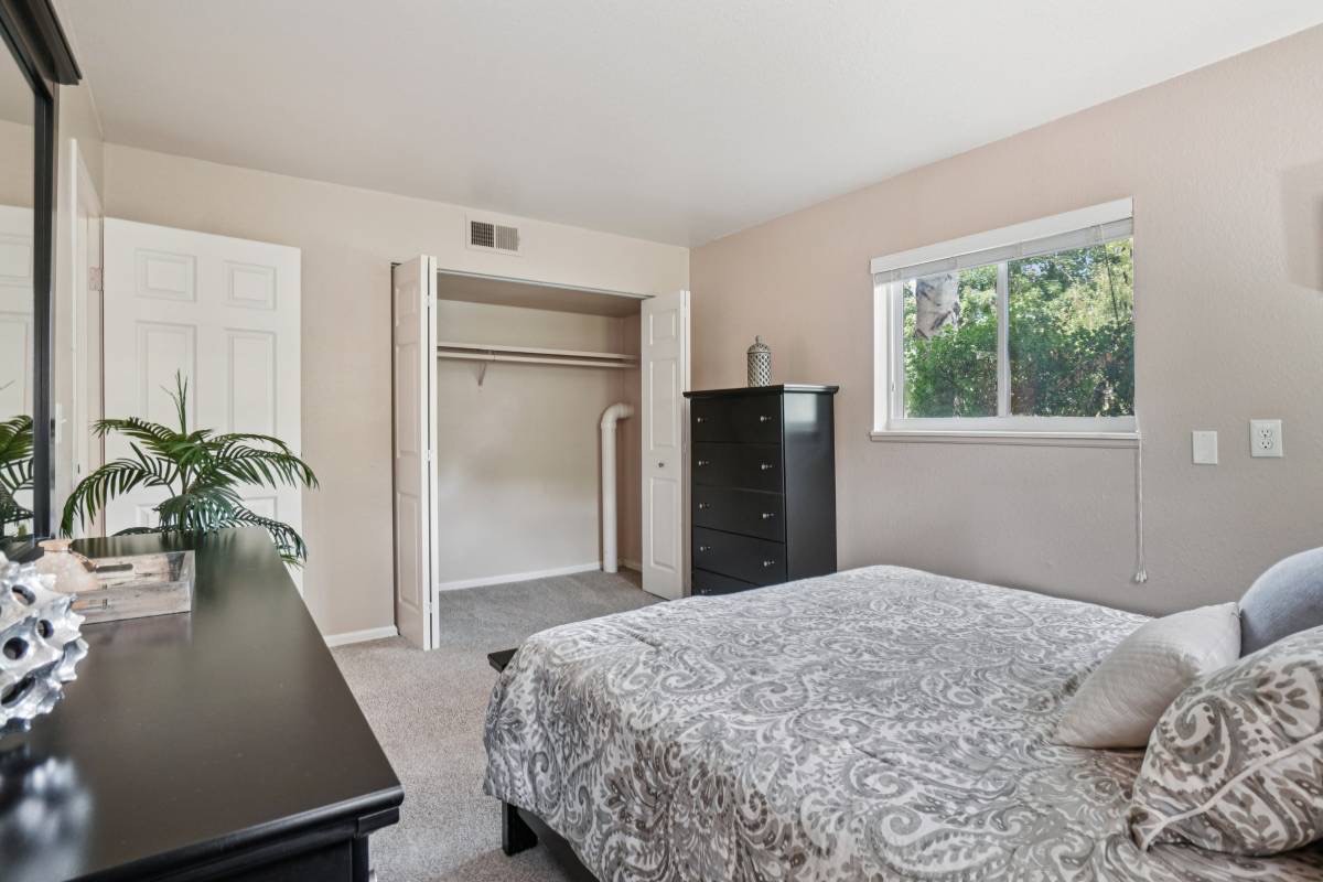 Furnished bedroom with walk-in closet